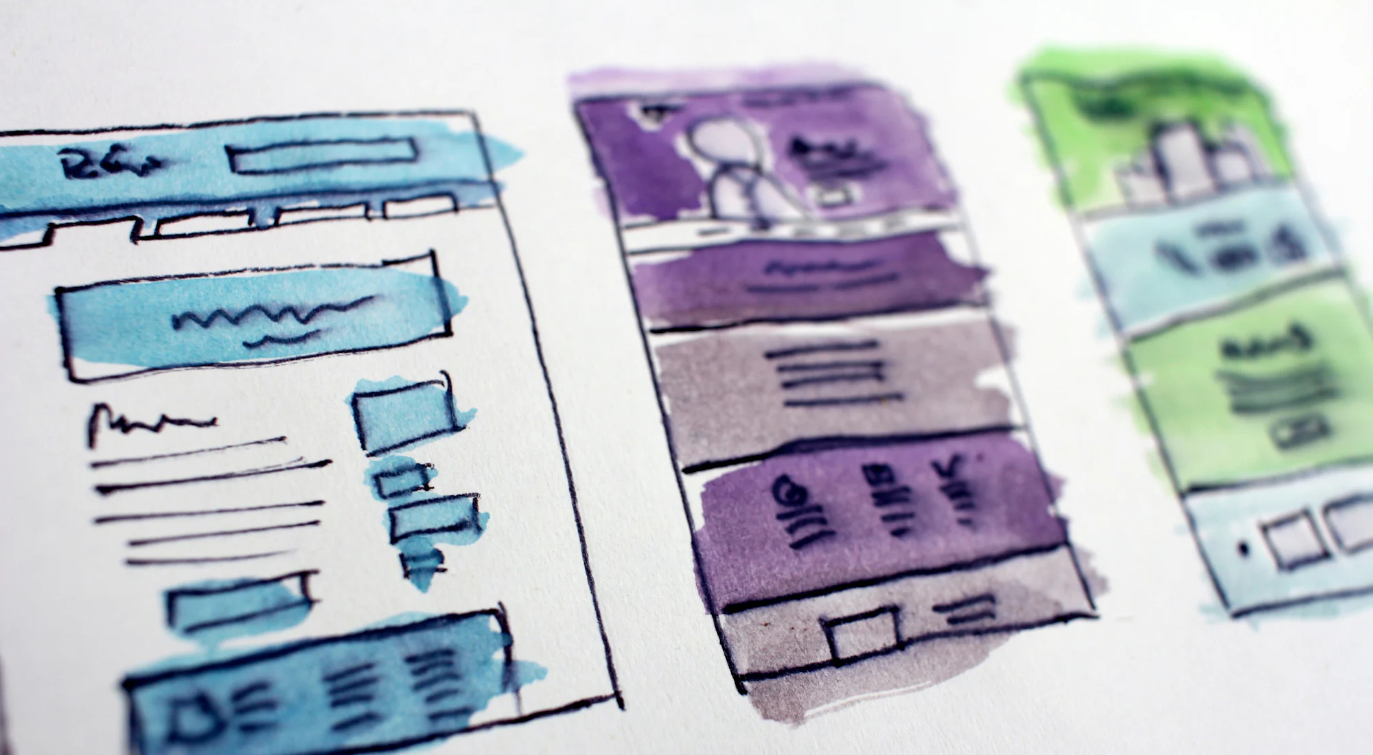 Hand-drawn wireframe sketches of website pages