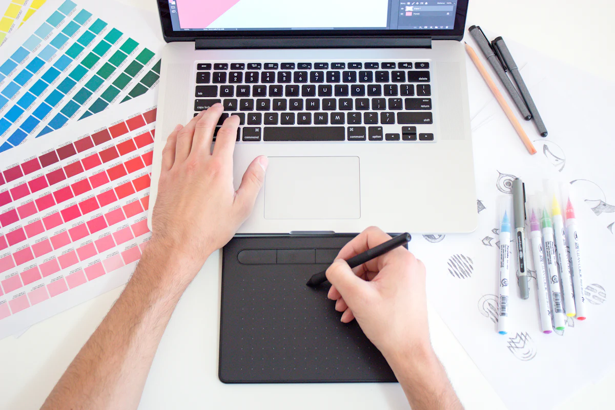 Designer working with a pen tablet and colour swatches